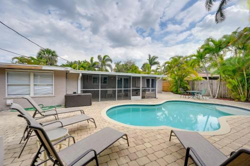 a swimming pool with chairs and a house at Pelican Nest, Tropical Naples Villa with Pool in Naples