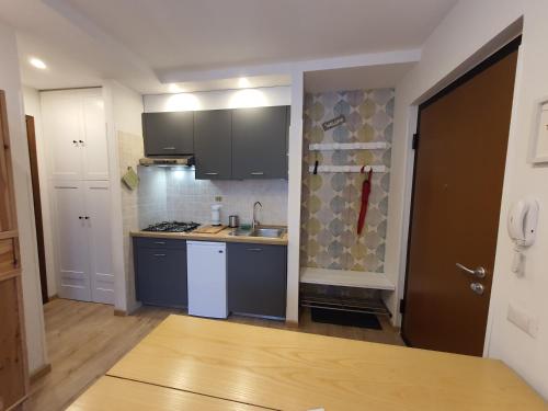 a small kitchen with blue cabinets and a sink at L' Orso Felice - alloggio turistico a Campo Felice in Collimento