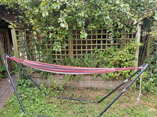 a hammock in a garden in front of a fence at Pilgrims of the Goddess in Glastonbury