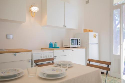 a kitchen with a table with two plates on it at Appartamento La Triglia 2 - HelloElba in Lacona