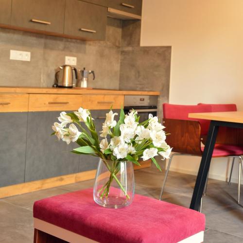 a vase filled with white flowers sitting on a table at Rezidence Valcha in Sušice