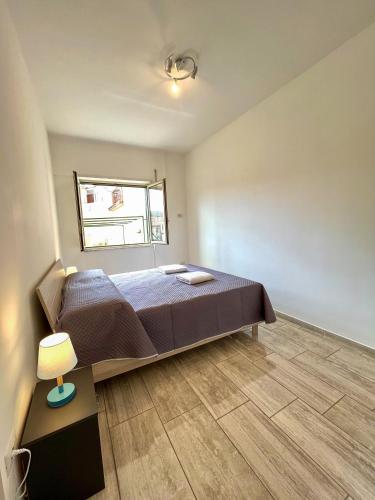 a bedroom with a bed and a lamp in it at Il Rifugio Dei Partenopei in Naples