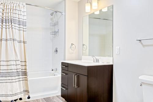 a bathroom with a sink and a tub and a toilet at Newly development 1BR w WD Gym in Cambridge BOS-462 in Boston