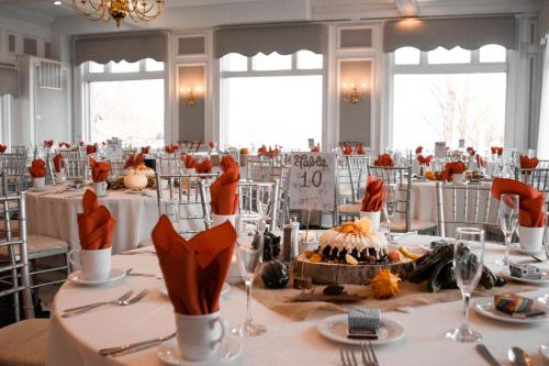 a banquet hall with a table with a cake on it at Fort William Henry Hotel in Lake George