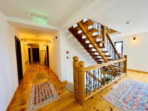 a wooden staircase in a room with wooden floors at PANORAMIC Sus In Deal in Vişeu de Jos