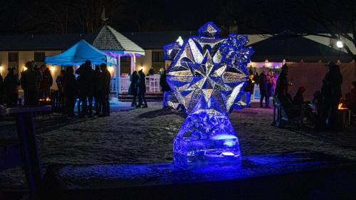a blue ice sculpture in the middle of a street at night at Fort William Henry Hotel in Lake George