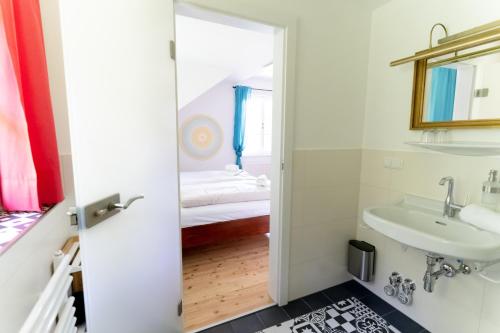 a bathroom with a sink and a bed at Villa Schwertführer in Velden am Wörthersee