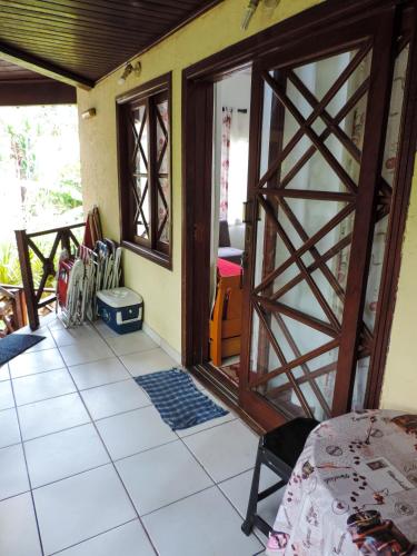 an open door to a room with white tile at Casa Canto do Mar Maresias 2 in Maresias
