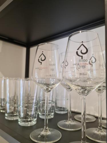 a group of wine glasses sitting on a table at Ferienwohnung Rosenberg in Konz-Oberemmel