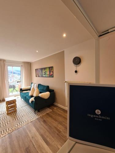 a living room with a couch and a flat screen tv at Ferienwohnung Rosenberg in Konz-Oberemmel