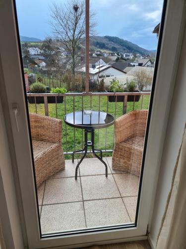 a view of a patio with a table and two chairs at Ferienwohnung Rosenberg in Konz-Oberemmel