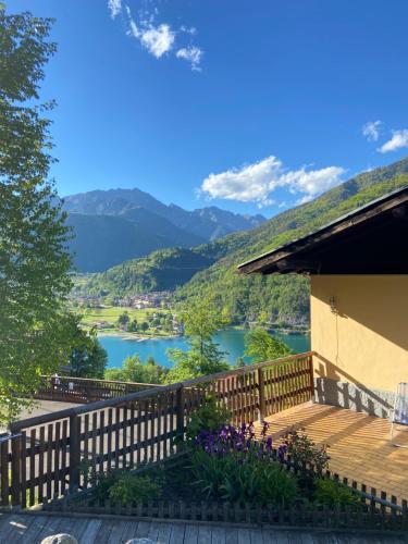 a balcony with a view of a lake and mountains at Ca' Romantica - Ledro House in Pieve Di Ledro