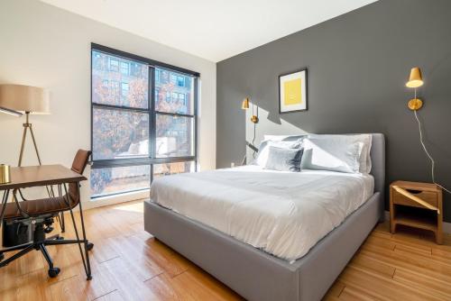 a bedroom with a bed and a desk and a window at S Boston 1BR w Doorman WD nr Seaport BOS-189 in Boston