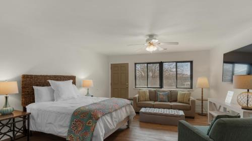 a bedroom with a bed and a couch and a chair at Hidden Beach 219 in Santa Rosa Beach