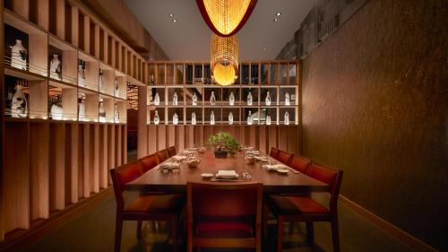 a dining room with a long table and chairs at Nobu Hotel Atlanta in Atlanta