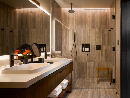 a bathroom with a large sink and a shower at Nobu Hotel Atlanta in Atlanta