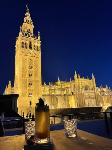 a large building with a clock tower at night at Casa ART Sevilla in Seville