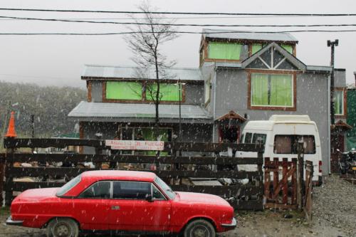 a red car parked in front of a house at Caballo de Fuego in Ushuaia