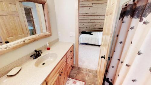 a bathroom with a sink and a mirror at Lakefront Hideaway in Litchfield