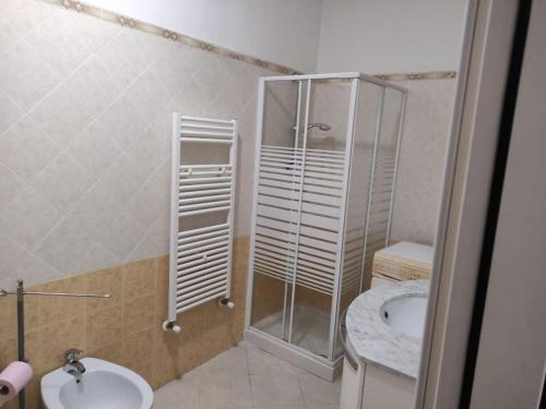 a bathroom with a shower and a toilet and a sink at antohouse intero appartamento R5883 in Quartucciu