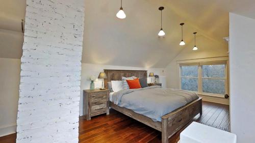a bedroom with a bed and a brick wall at Linden Hills Luxury Charmer in Minneapolis