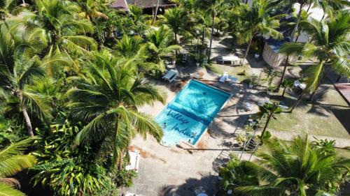 an overhead view of a swimming pool with palm trees at Indaiá Eco Village in Ilhéus