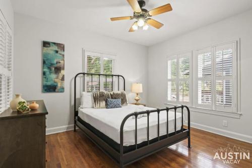 a bedroom with a bed and a ceiling fan at Vibrant, Quirky Home with Hot Tub Near S Congress in Austin