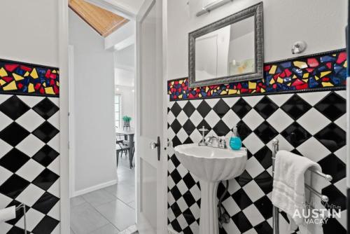 a bathroom with a sink and a mirror at Vibrant, Quirky Home with Hot Tub Near S Congress in Austin