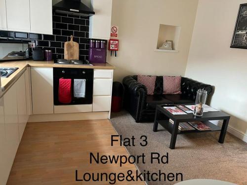 a kitchen with a couch and a table in a room at Stafford apartments in Stafford