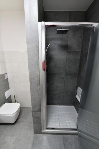 a shower stall in a bathroom with a toilet at Pensjonat Zuzanna in Hajnówka