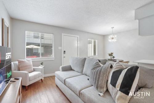 a living room with a couch and a chair at Cook and Gather Around in a Fully Equipped Apartment in Austin