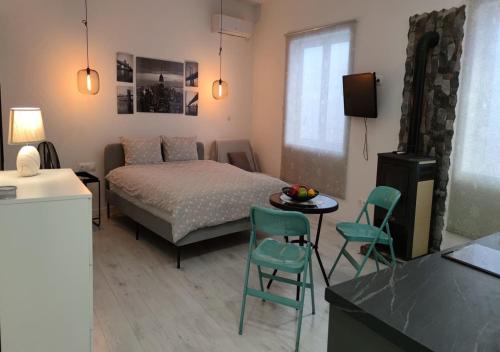 a bedroom with a bed and a table and chairs at PALAIO FALIRO SUITE DELUX NEAR THE SEa in Athens