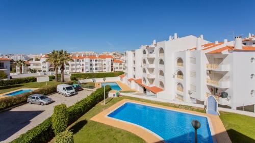 a villa with a swimming pool and a building at Sun-kissed Oasis W/ Pool by LovelyStay in Albufeira