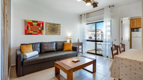 a living room with a couch and a table at Sun-kissed Oasis W/ Pool by LovelyStay in Albufeira