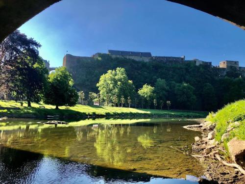 a view of a river from under a bridge at Café du Pêcheurs in Bouillon