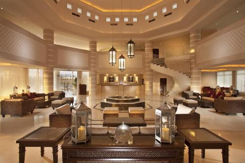 a living room with a lobby with tables and chairs at Jaz Sharks Bay in Sharm El Sheikh
