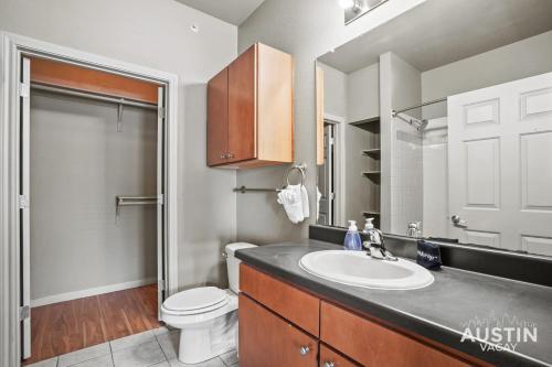 a bathroom with a sink and a toilet at King Beds and Patio Dining in ATX West Campus Gem in Austin