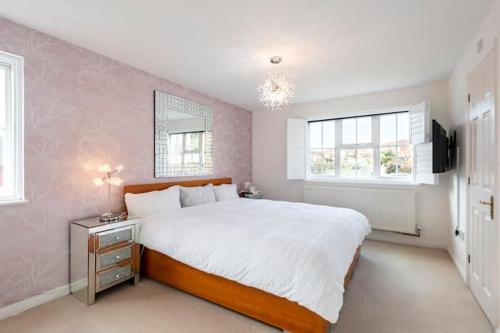 a bedroom with a large white bed and a window at BIENVENUE in NEWHAVEN Luxury superking OR standard OR budget rooms in Newhaven