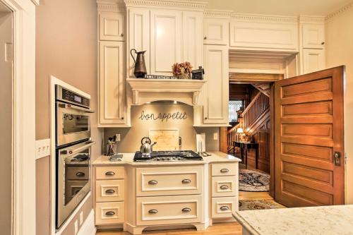 a kitchen with white cabinets and a sink at Dog-Friendly Home with Balcony and Yard in Surgeon Bay in Sturgeon Bay
