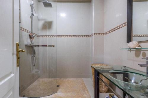 a bathroom with a shower and a glass sink at Appartement 2 chambres in Marrakesh