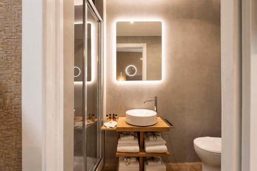a bathroom with a sink and a toilet and a mirror at Royal Rooms Corso in Rome