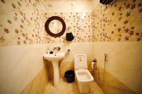 a bathroom with a sink and a toilet at The Location, A Penthouse in Dehradun