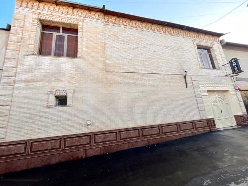 a brick building with a window and a door at Hamida in Samarkand