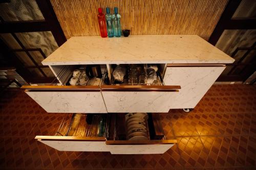 a shelf in a room with bottles on it at The Location, A Penthouse in Dehradun