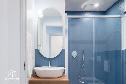 a bathroom with a sink and a glass shower at Atlantis Home in Cagliari