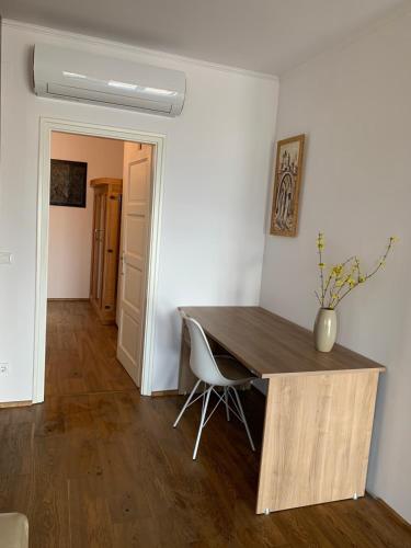 a room with a wooden table and a chair at Hilltop Apartments in Fonyód