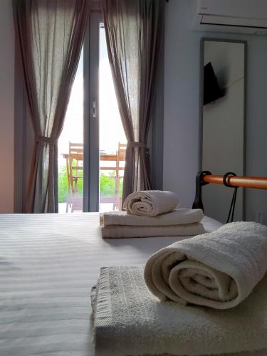 a bedroom with a bed with towels on it at Nefeli in Livadion