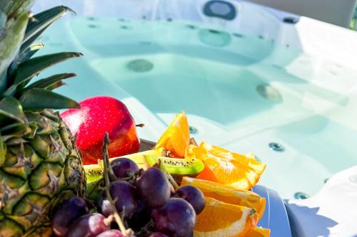 a plate of fruit on a table with a pineapple at Playa Palmera Beach Resort in Punta Cana