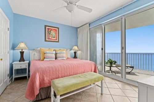 a bedroom with a bed and a balcony at Twin Palms 1705 in Panama City Beach