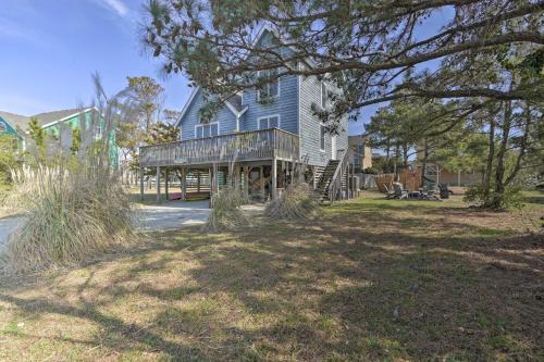 a large house with a deck and a yard at Hot Tub, Pirate Fort and Fire Pit Outer Banks Home! in Nags Head